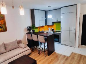 a kitchen with a couch and a table in a room at Apartament Podmiejska in Jastrzębie Zdrój +5 photos
