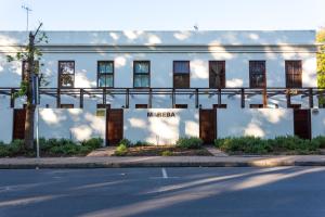 a white building with a sign on the side of it at Avemore Mareba Court No 9 in Stellenbosch