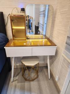 a dressing table with a mirror and a stool at Spacious 2 King Bed Family Room 56 Sqm PODOMORO APARTMENT Tower Liberty 21st Floor with Mall Direct Access in Medan