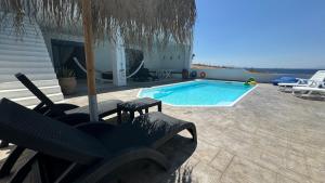 The swimming pool at or close to NV seafront villa Aegina 1