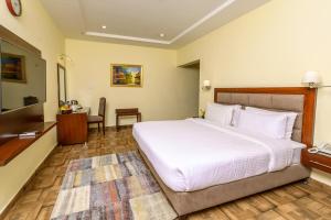 Postel nebo postele na pokoji v ubytování Hotel One Sahiwal