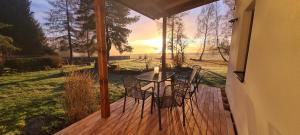 a patio with a table and chairs on a deck at HabaChalupa in Šumperk +15 photos