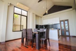 a kitchen and dining room with a table and chairs at Sourire at Rattanakosin Island Hotel in Bangkok