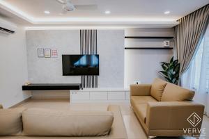 a living room with a couch and a flat screen tv at Ipoh Mansion House 25 by Verve in Ipoh