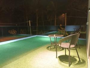 a patio with two chairs and a table and a pool at J Garden Village in Muar