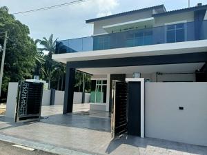 a building with two open doors in front of it at J Garden Village in Muar