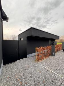 a black building with a large garage at The Box in Sint-Pieters-Leeuw +10 photos
