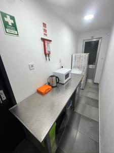 a room with a counter with a microwave on it at ESTANQUEIRA GUEST HOUSE in Sines