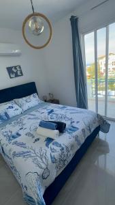 a bedroom with a bed with a blue and white comforter at BLUE LATSI in Lachi