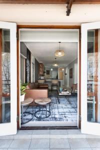 a living room with a couch and a table at Avemore Jan Cats No 3 full back up power in Stellenbosch +19 photos