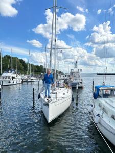 a man standing on a sail boat in the water at Haus 2 in Klenzau