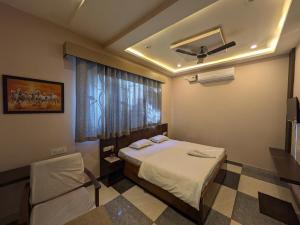 a hotel room with a bed and a window at Kishori Vatika in Rāmnagar