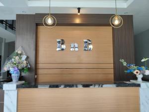 a lobby with a wooden door with lights and flowers at BnB Home in Blimbing