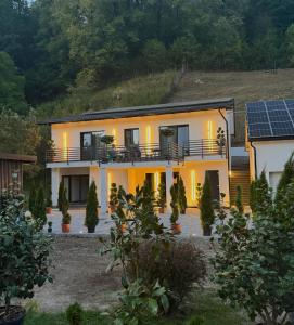 a house with solar panels on the side of it at Hotel Casa Blanca in Tulgheş