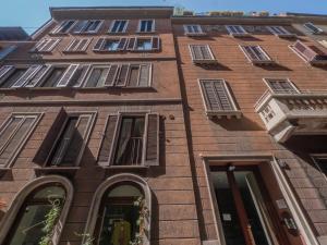 a tall brick building with windows on it at Italstay - Disciplini Duplex - 10 min dal Duomo in Milan +5 photos