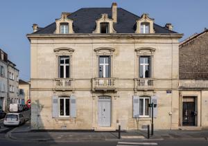 an old stone building with a black roof at Appartement de Prestige Emeraude 60m2 in Périgueux