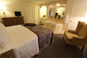 a bedroom with a bed and a bathroom with a sink at InnSeason Resorts The Falls at Ogunquit in Ogunquit +14 photos