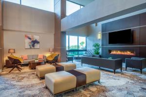 a living room with a couch and a fireplace at Wyndham Indianapolis Airport in Indianapolis