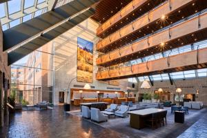 恩格尔伍德The Inverness Denver, a Hilton Golf & Spa Resort的酒店大堂里摆放着桌椅