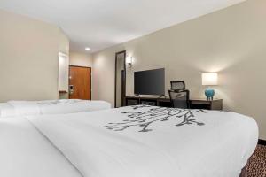 a hotel room with two beds and a flat screen tv at Sleep Inn & Suites Montgomery East I-85 in Montgomery