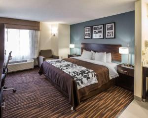 a hotel room with a large bed and a window at Sleep Inn Greensboro Airport in Greensboro +23 photos