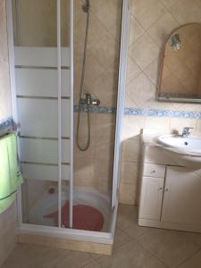 a bathroom with a shower and a sink at Casa do Mar - Praia de Manta Rota in Vila Nova de Cacela +11 photos