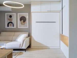 a living room with a couch and a sliding glass door at Parkside Haven in M. Ciurel