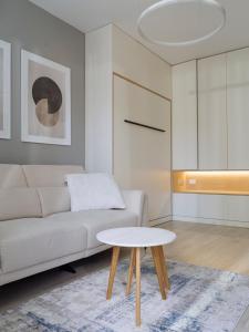 a living room with a white couch and a table at Parkside Haven in M. Ciurel +107 photos