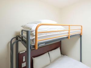 two bunk beds in a room with a bed at Comfort Inn Utsunomiya Kanuma in Utsunomiya
