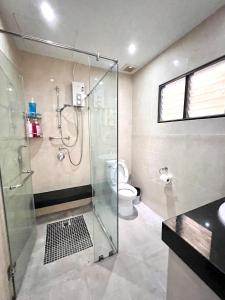 a bathroom with a glass shower and a toilet at Comfort Home Patong in Patong Beach
