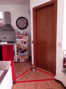 a kitchen with a door with a red ribbon on the floor at Rosso rubino in Rome