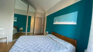 a bedroom with a blue wall and a bed at Casa Dante in Turin