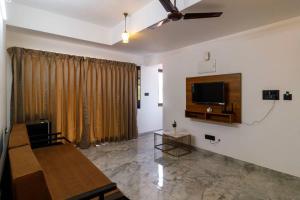 a living room with a flat screen tv on the wall at Casa Quina Heritage#3 in Taleigao
