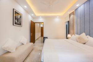 a hotel room with two beds and a couch at Kyomi Service Apartments in Gurgaon