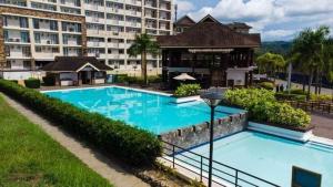 a large swimming pool in front of a large building at One Oasis Cagayan De Oro 2-Bedroom Unit in Cagayan de Oro