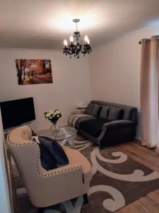 a living room with a couch and a table at Homely Space in Havering, Essex in Havering atte Bower