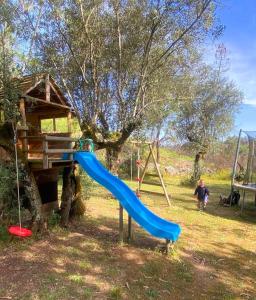 a blue slide on a playground in a yard at Quinta Vida Verde in Alvaiázere