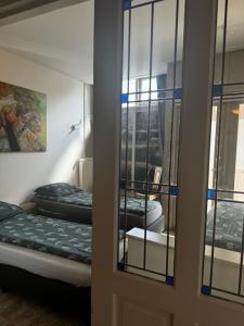 a room with two beds and a mirror at Friend zone in Zaandam