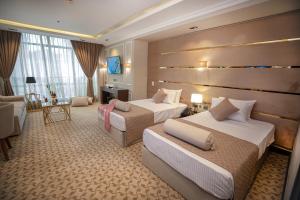 Postel nebo postele na pokoji v ubytování Cairo Taj Hotels & Suites- Mohandessin + 37 fotografií