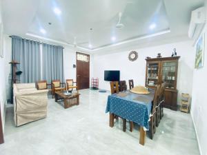 a living room with a table and a couch at Blue Star Apartments in Dehiwala