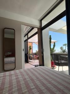 a bedroom with a bed and a view of a patio at Ocean blue 405 in San Bartolomé +24 photos