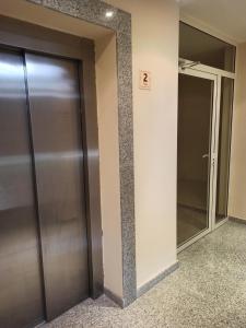an elevator in a building with a glass door at Argisht complex apart 208 in Golden Sands