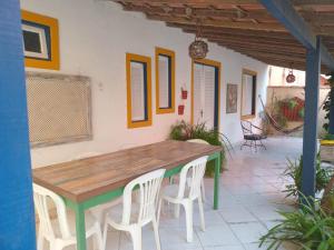 a wooden table and chairs on a patio at Casa em Cabo Frio in Cabo Frio +47 photos