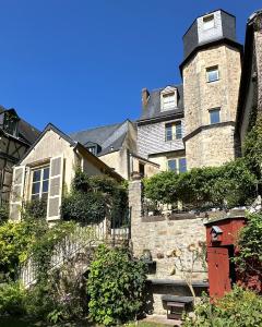 a large stone building with a staircase in front of it at Logis Saint-Flaceau in Le Mans