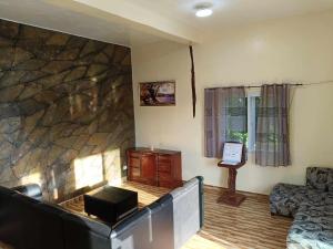 a living room with a large stone wall at Whitesands Beach Resort in San Isidro