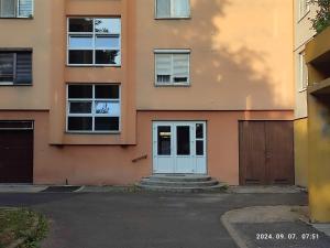 an apartment building with a blue door and windows at LBB apartman in Sátoraljaújhely