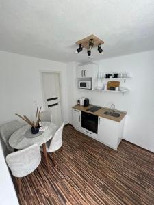 a kitchen with a table and chairs and a sink at Queen Apartment city Center in Mediaş