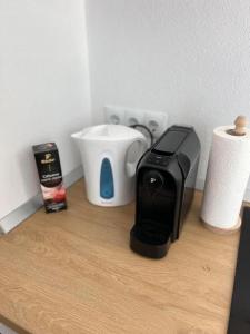 a counter with a toaster and a coffee maker on it at Queen Apartment city Center in Mediaş