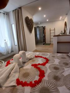 two stuffed animals sitting on a bed in a room at Maison cosy entre mer et garrigue in Pomérols