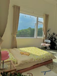 a bedroom with a bed and a large window at Ghé nhà mình Homestay in Ấp Trạm Hành